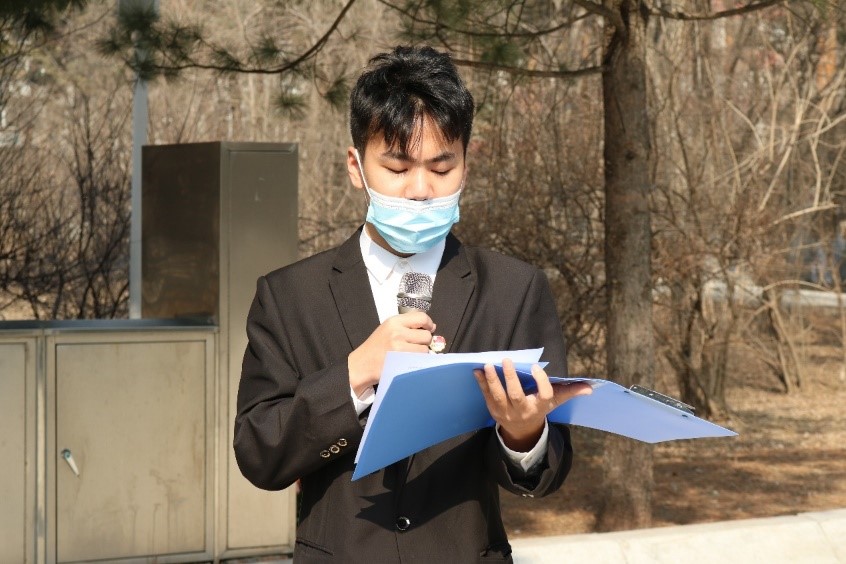 穿着西装笔挺的男子手里拿着手机  低可信度描述已自动生成